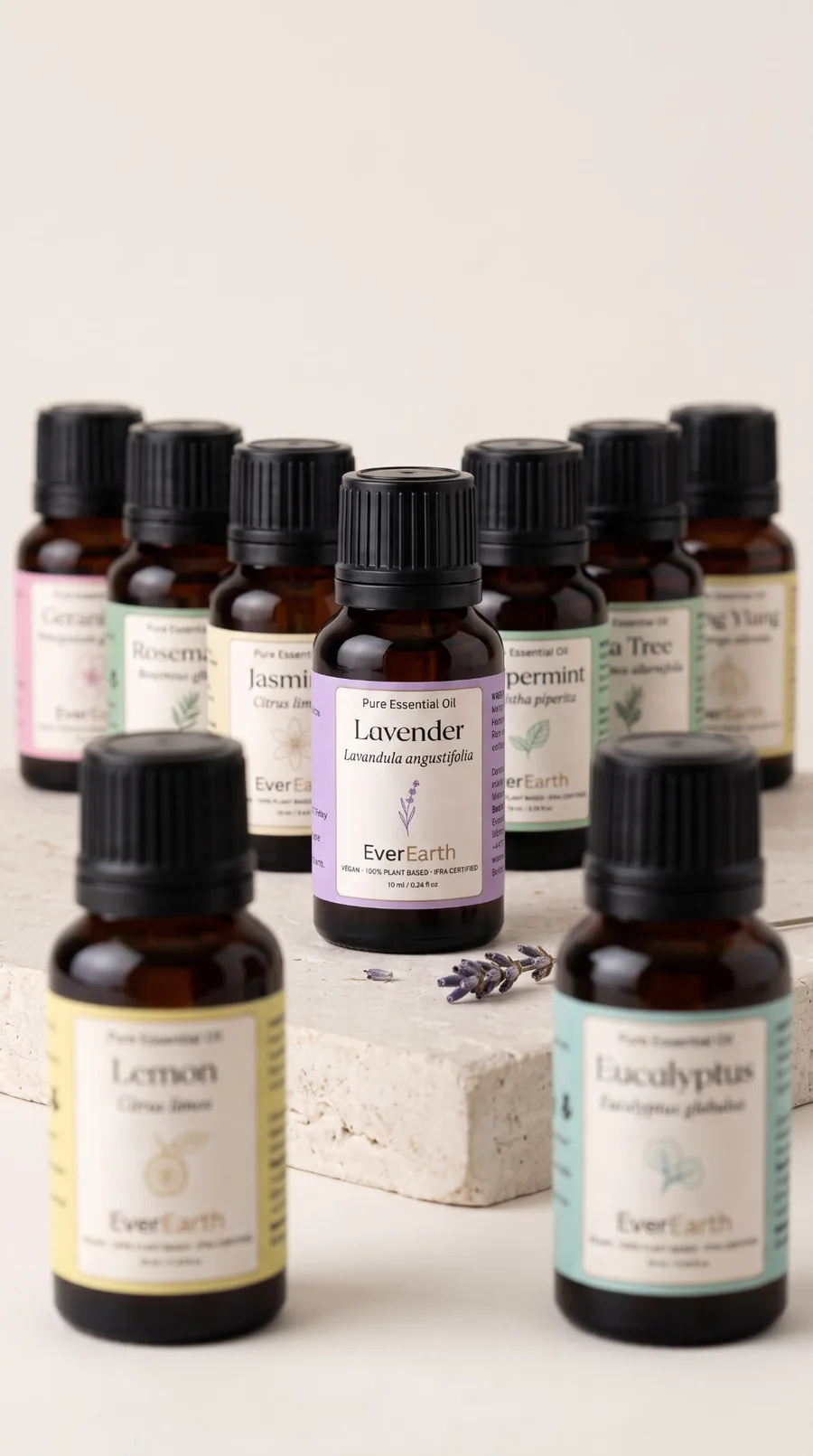 EverEarth collection of pure essential oils in amber glass bottles on stone pedestals